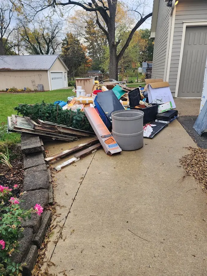 Dumpster being loaded with debris for Roofing Dumpster Rental in Jackson